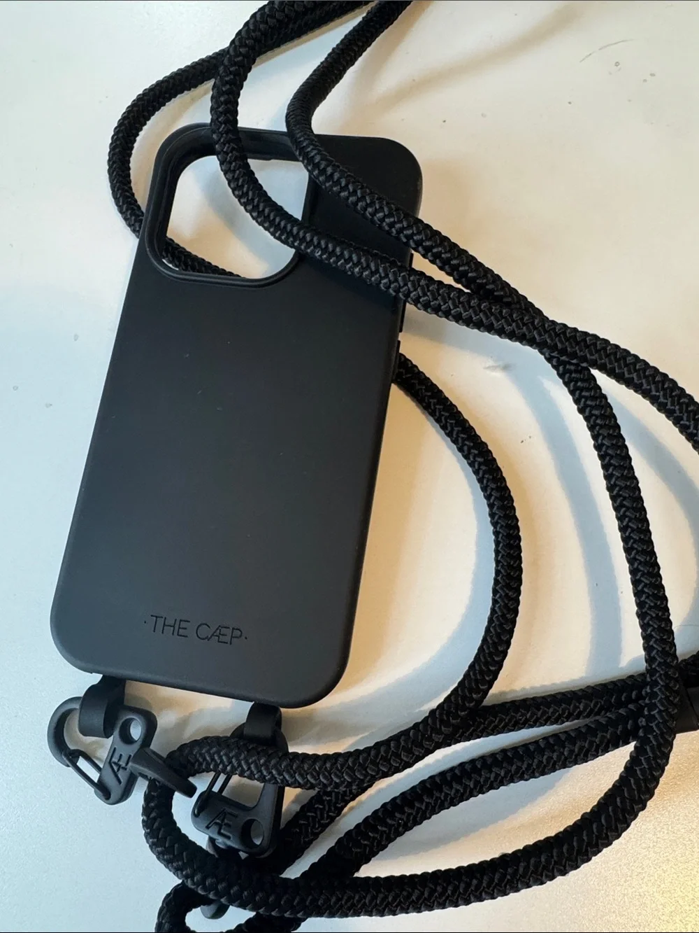 The Caep Black Crossbody Phone Case with Adjustable Rope Strap